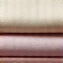 A neatly folded stack of finished fabric representing production and delivery